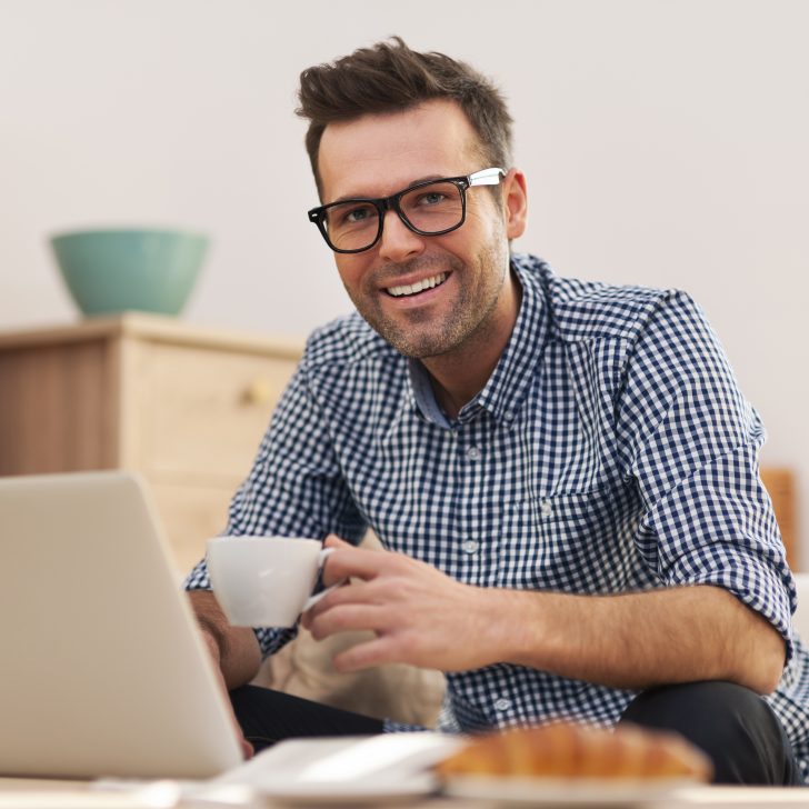 Portrait of smiling man working at home